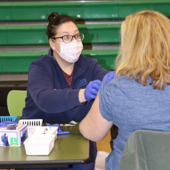 LM nurse administering COVID vaccine