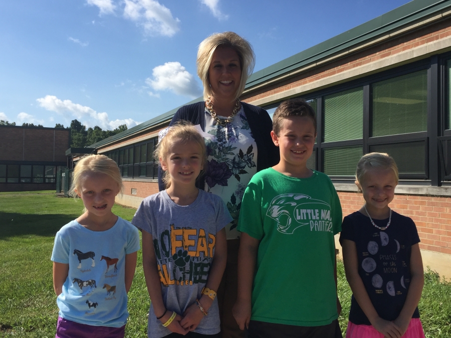 Photo of principal and four students